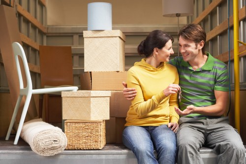 Packed moving boxes and furniture prepared for domestic removals in West Kensington